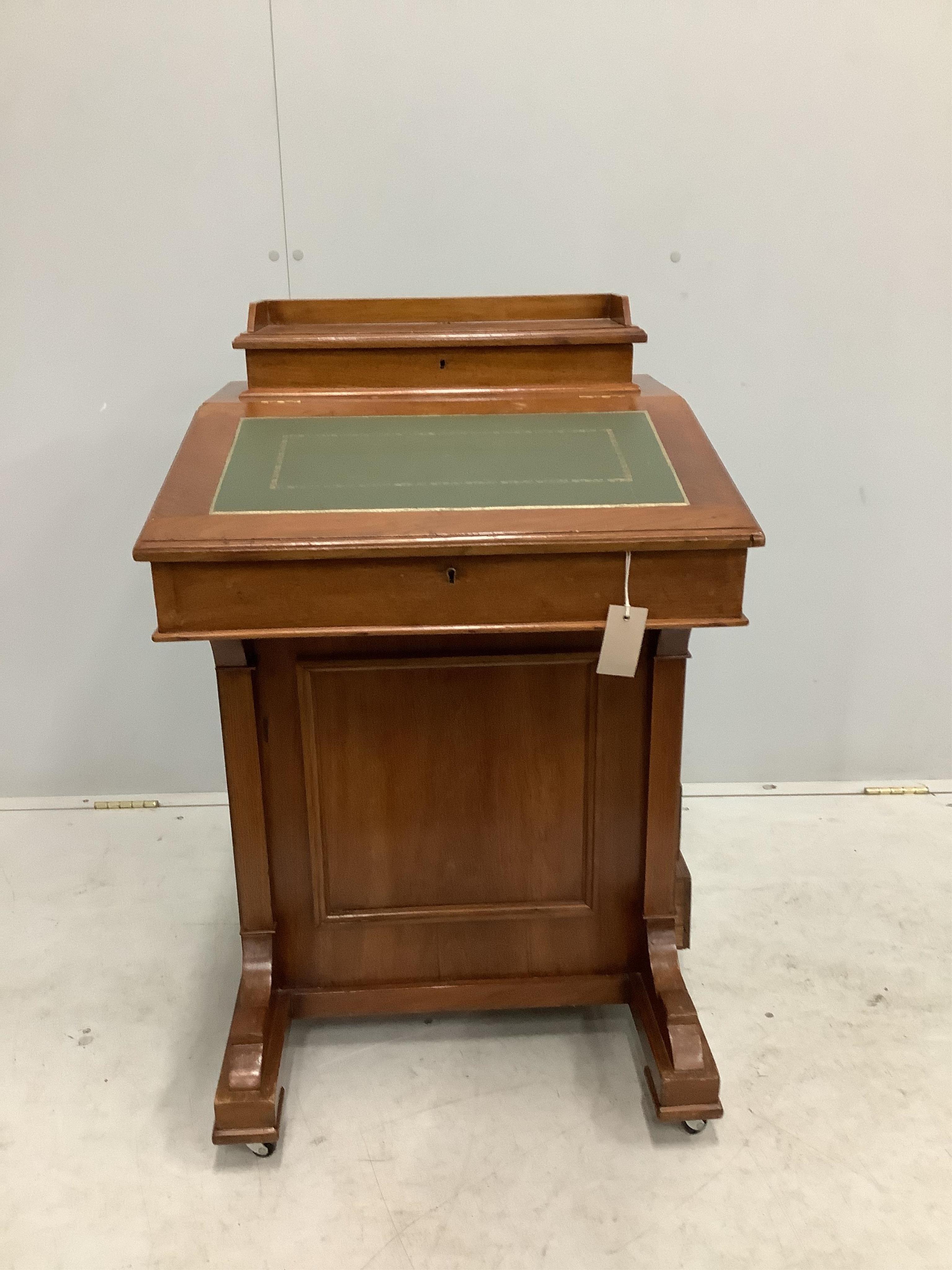 A late Victorian walnut Davenport, width 55cm, depth 53cm, height 87cm. Condition - fair